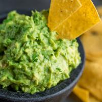 Guacamole Dip with Warm Corn Tortilla Chips and Sour Cream · 
