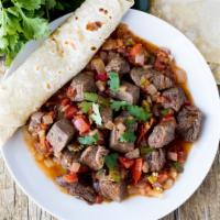 Romanian Skirt Steak A La Mexicana · Skirt steak with sauteed jalapeno, onions and tomatoes. Served with homemade black beans, ri...