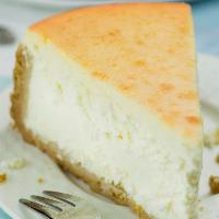 Classic New York Cheesecake · Tall and creamy New York cheesecake. Served with vanilla bean whipped cream. Top it with ice...