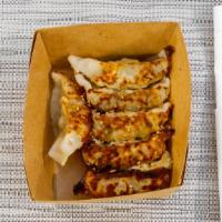 Chicken and Pork Gyoza  · 6 pieces of chicken and pork gyoza topped with sesame seeds. Served with a side of gyoza sau...