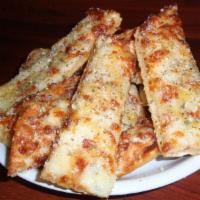 Garlic Cheese Bread · Fresh bread sticks brushed with butter and topped with minced garlic, mozzarella and Parmesa...