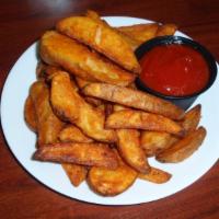 1 lb Fries · One pound of seasoned wedge fries served with a side of ketchup.