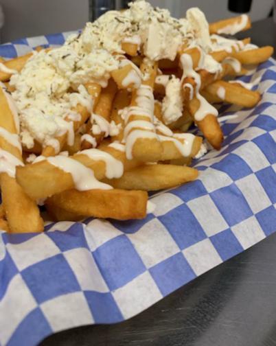 Greek Feta Fries · Our seasoned fries topped with whipped and crumbled feta.