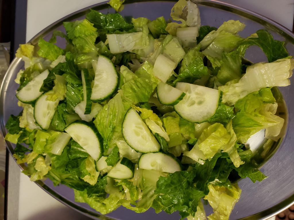 Greek Green Salad · Maroulo salata. Romaine lettuce, cucumbers, green onions, topped with our very own Greek dressing.