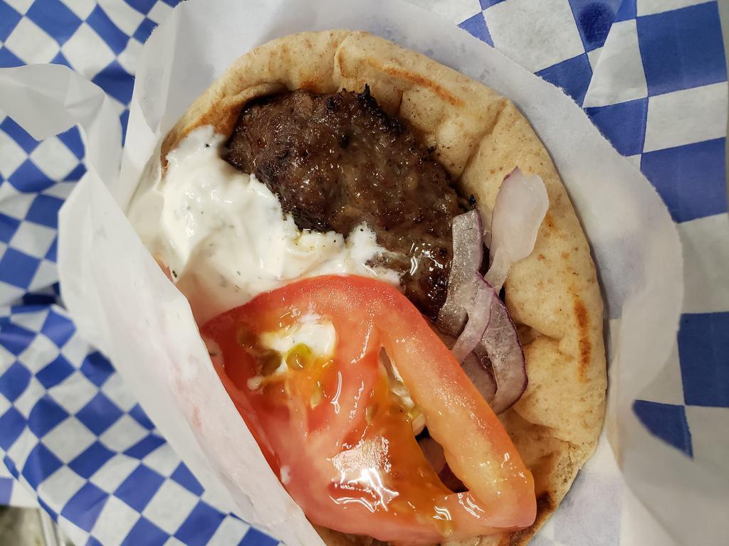 Bifteki Pita · Fresh angus ground beef strips wrapped in choice of pita with tzatziki, red onions and tomatoes served with salad and side