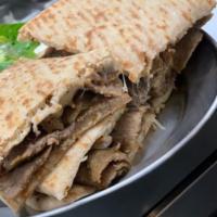Gyro Melt · Our delicious gyro meat sandwiched between two pita's with choice of cheese served with tzat...