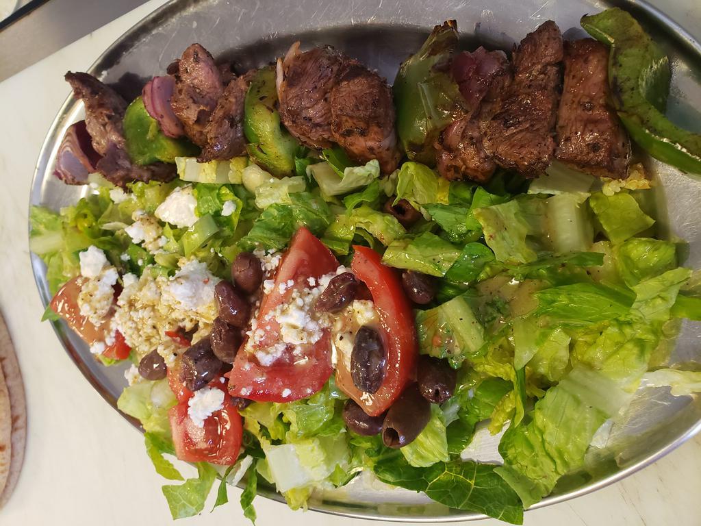 Charbroiled Beef Skewer · Greek style marinated beef sirloin skewer with bell peppers and onions, Athenian salad, pita, tzatziki and choice of side