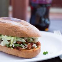 Torta · A Mexican sandwich that includes beans, lettuce, tomato, sour cream, cheese and your choice ...