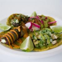 The Taco Plate · 4 tacos of your choice on corn tortilla. includes rice & refried beans