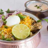 Hyderabadi Chicken Biryani · Chicken cooked in basmati rice with special herbs and spices. Your choice of vegetables, chi...