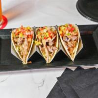 Pulled Pork Tacos · Three homemade Mojo marinated pork tacos filled with
shredded lettuce, topped with Maui sauc...