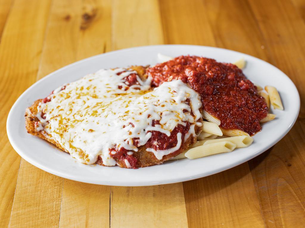 Chicken Parm · A portion of breaded chicken cutlet topped with homemade marinara sauce and mozzarella cheese. Served with pasta and a salad.
