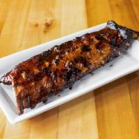 Full Rack Baby Back Ribs · Full rack of baby back ribs. Served with a side and salad.