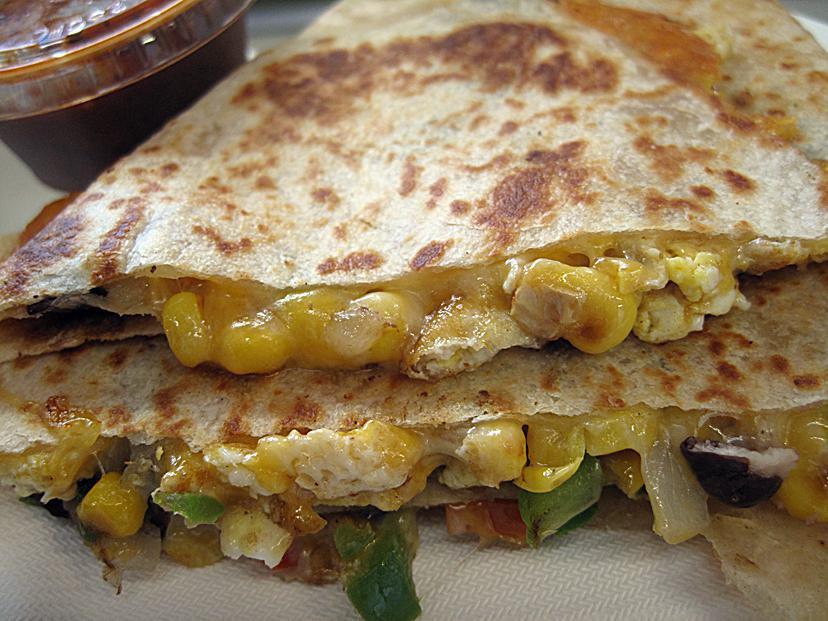 Veggie Quesadilla · A mixture of Corn Black beans, Onions, Bell peppers, Cheese with hot sauce, and sour cream on the side.