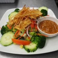 Thai Salad · Mix greens, carrot, cucumber, tomato, onion topped with fried tofu; serve with peanut dressi...