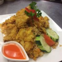Fried Shrimp Over Fried Rice · Jasmine Thai rice stir-fried with pea, carrot, egg, topped with fried shrimp, served with Th...