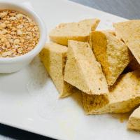  1. Crispy Tofu  · Golden fried tofu with a crispy served with sweet and sour sauce and crushed peanut.