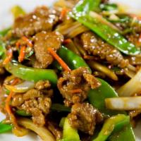 Ginger Beef · Sliced beef sauteed with  ginger, green and white onions, green peppers and peanods in brown...