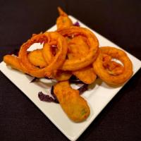 Vegetarian Pakora · Onions, jalapenos and potatoes marinated in our homemade batter and fried. Spicy. Vegetarian...