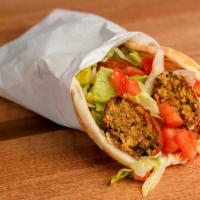 Falafel Pita Sandwich · Garlic paste, hummus, lettuce, tomato and topped off with tahini.