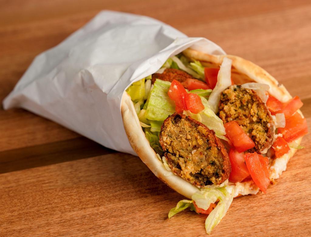 Falafel Pita Sandwich · Garlic paste, hummus, lettuce, tomato and topped off with tahini.