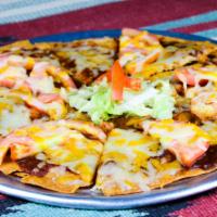 New Mexican Pizza · Crispy flour tortilla with melted cheese, red chile and tomatoes. Spicy.