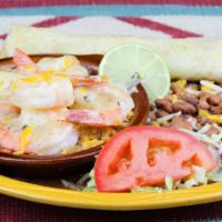 Garlic Shrimp · Large shrimp seasoned in garlic with cheese served over rice with a side of beans and a home...