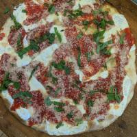 Grandma Pizza · Thin pan pizza with garlic, tomato sauce, fresh mozzarella and pecorino romano. Please speci...
