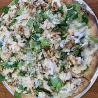 Grilled Chicken Caesar Salad Pizza · Round style pizza topped with fresh romaine lettuce, grilled chicken, & caesar dressing 