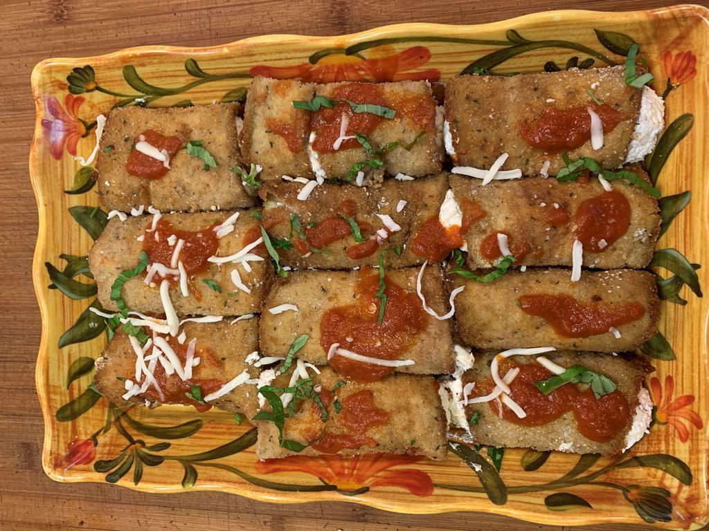 Eggplant Rollatini Entree · (2) Large breaded eggplant rolls stuffed with herbs & fresh ricotta cheese smothered with marinara sauce & topped with melted mozzarella served over fresh pasta.