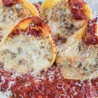 Stuffed Shells · Large pasta shells stuffed with beef, pork, cheese and herbs, then baked with marinara. Serv...