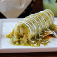 Burrito Amigo · Chicken or steak, refried beans, rice lettuce, cheese, crema fresca - smother in queso or to...