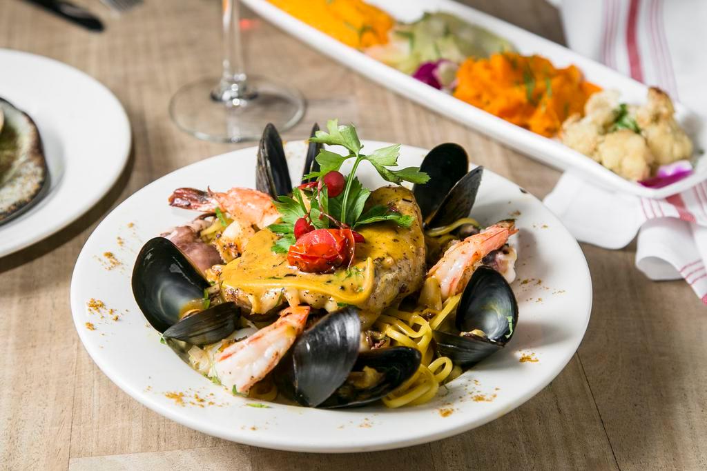 Seafood Linguini · Seafood linguini with white wine saffron sauce, dressed with scallop, mussels, white meat, fish filet, calamari and shrimp.