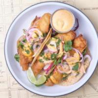 Baja Fish Tacos · crispy fried cod in nixtamal corn tortillas
with citrus arugula, cabbage slaw, chipotle may...