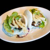 Pork Belly Buns · 2 steamed bun, grilled pork belly, lettuce topped with fried onion, cilantro and sauce.