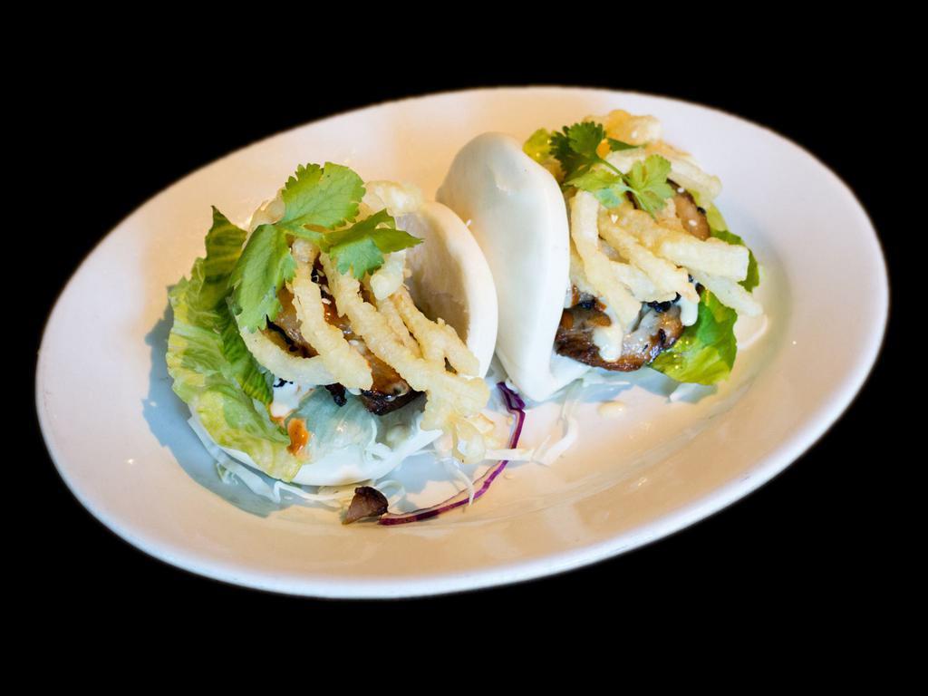 Pork Belly Buns · 2 steamed bun, grilled pork belly, lettuce topped with fried onion, cilantro and sauce.