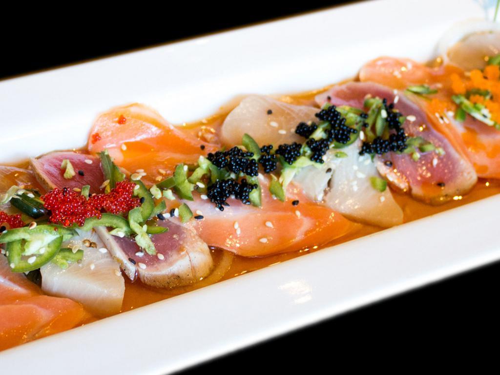 Rainbowfin · 9 pieces of thinly sliced albacore in ponzu topped with wakame, jalapenos, tobiko and sauce.