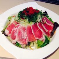Seared Ahi Tuna Salad · Bed of mix greens topped with wakame, cucumber pasta, tobiko and sweet sesame soy dressing.