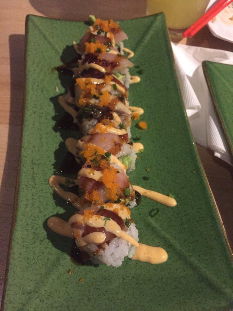 Yakuza Roll · Yellowtail, spicy tuna, avocado top with albacore, unagi, scallions and masago. Teriyaki and spicy mayo.