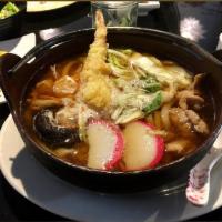 Nabeyaki Udon noodle soup · vegetables, mushroom and cracked egg in broth.