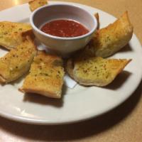 Garlic Bread · Fresh bread seasoned with garlic, butter and spices with homemade marinara sauce. Vegetarian.