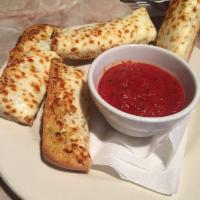 Cheese Bread · Garlic cheese bread topped with mozzarella and Parmesan cheese with homemade marinara sauce....