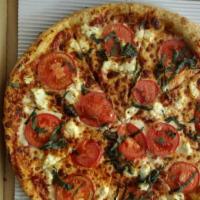 19. Margherita Pizza · Tomatoes, fresh garlic, fresh basil and mozzarella cheese. Vegetarian.