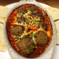 Polpette · Homemade meatballs baked in pomodoro sauce, finished with mozzarella and Parmesan cheese, se...
