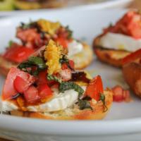 Bruschetta al Pomodoro · Chopped fresh tomatoes with garlic, basil, olive oil, and balsamic vinegar served on toasted...