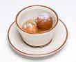 Gulab Jamun · Soft dumpling made of dry milk soaked in warm rose flavored sugar syrup garnished with coconut.