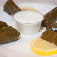 Grape Leaves · 6 pieces. Stuffed with rice, diced parsley, and onions cooked in olive oil. served with tzat...