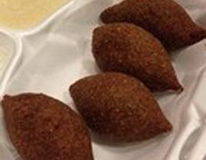 Kibbeh (4) (Halal حلال) · 4 pieces. Football shaped shell made of bulgur (cracked wheat) and lean sirloin pate stuffed with ground beef, onions, and pine nuts, then lightly fried.