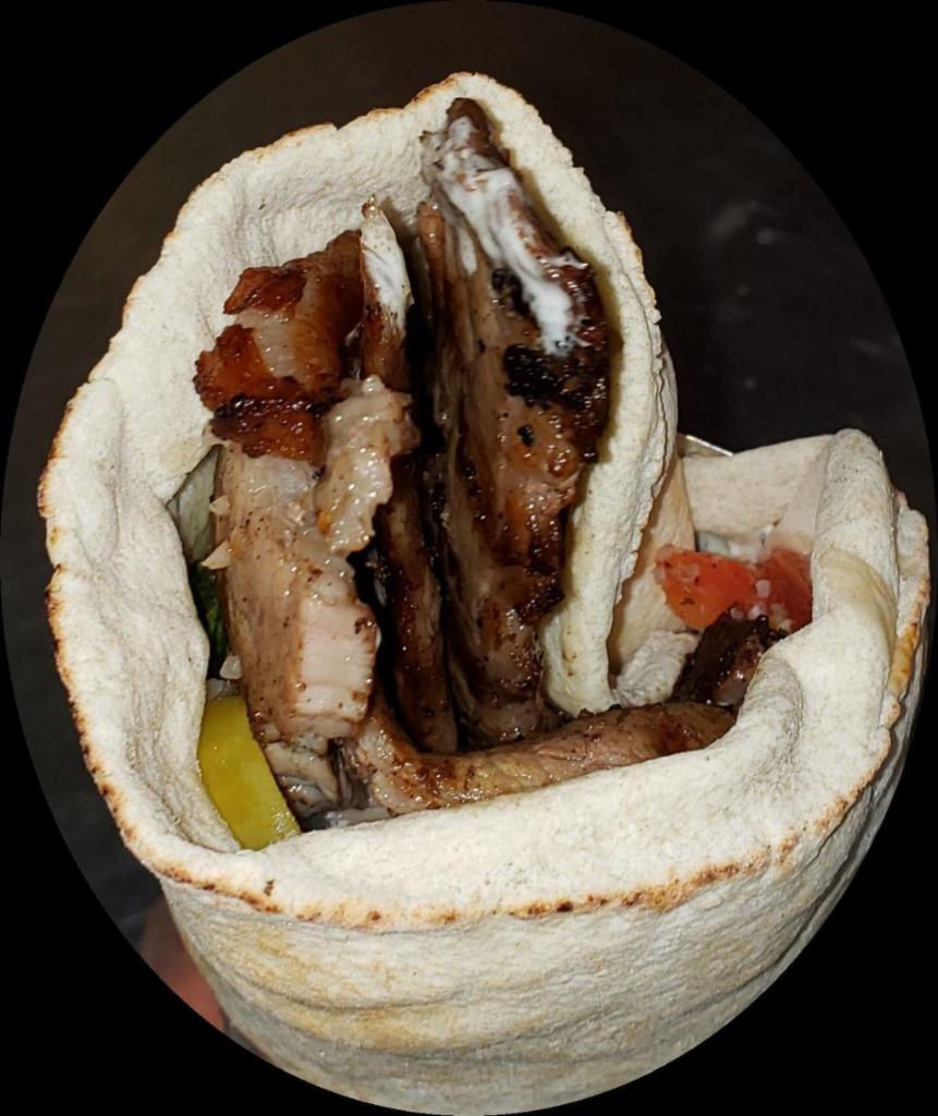 Beef Steak Kabob Wrap · Extra-lean eye round beef thinly sliced, seasoned and grilled. Served with hot sauce, hummus, lettuce, tomato, onions, hot peppers, pickle, tabouleh, tahini and a yogurt-cucumber sauce.