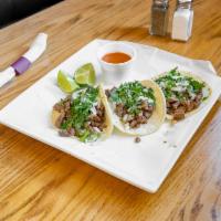 Tacos de Carne Asada · Recommended. Grilled steak topped with onions & cilantro and tomatillo sauce on the side.